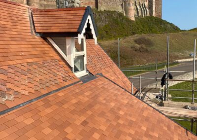 St Aidan’s Holiday Home, Bamburgh, Northumberland, Rosemary Clay Tile Multi-Elevation Re-Roof, Sarking Board Reconstruction and Renewal, Triple Code 4 Lead Valley Installation, Manthorpe Linear Verge System, Manthorpe Dry Ridge System  with CREST Rustic Universal Ridge Tiles, Full Half-Round DeepFlow Guttering System, Dormer Reconstruction, Double Firestone EPDM Rubber Internal Warm Flat Roof System, new Code 4 Leadworks and Multi-VELUX Conservation Window Installation Project